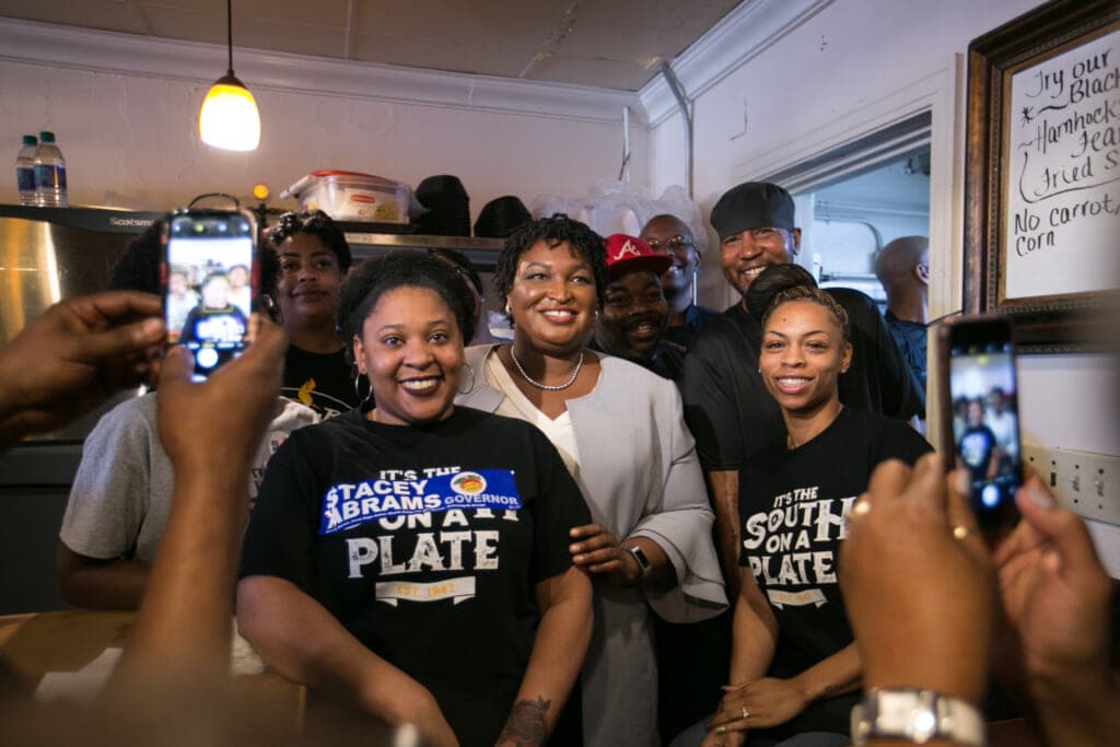 During her run for Georgia governor, Stacey Abrams (center) posed with employees of Busy Bee Cafe in Atlanta