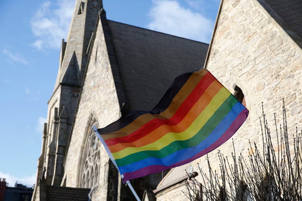 An LGBTQ+ flag flies over Union United Methodist Church in Boston