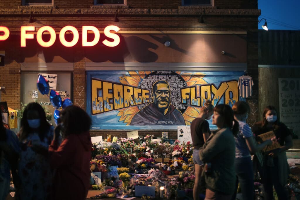 People visit a memorial at the site where George Floyd was killed