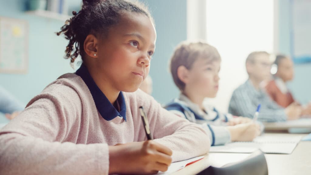 Children sitting at desks in a classroom