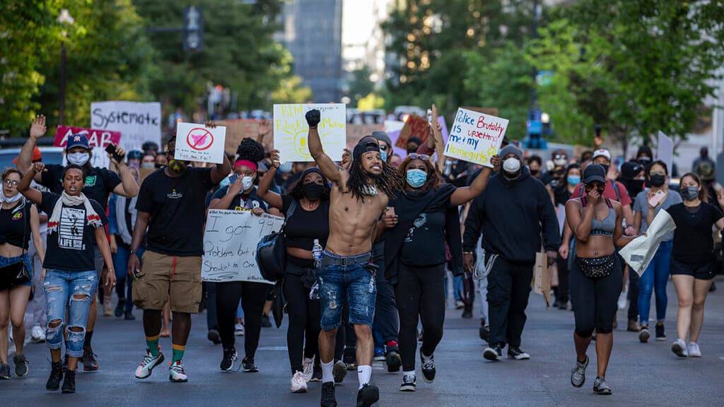Police work to keep demonstrators back during a protest