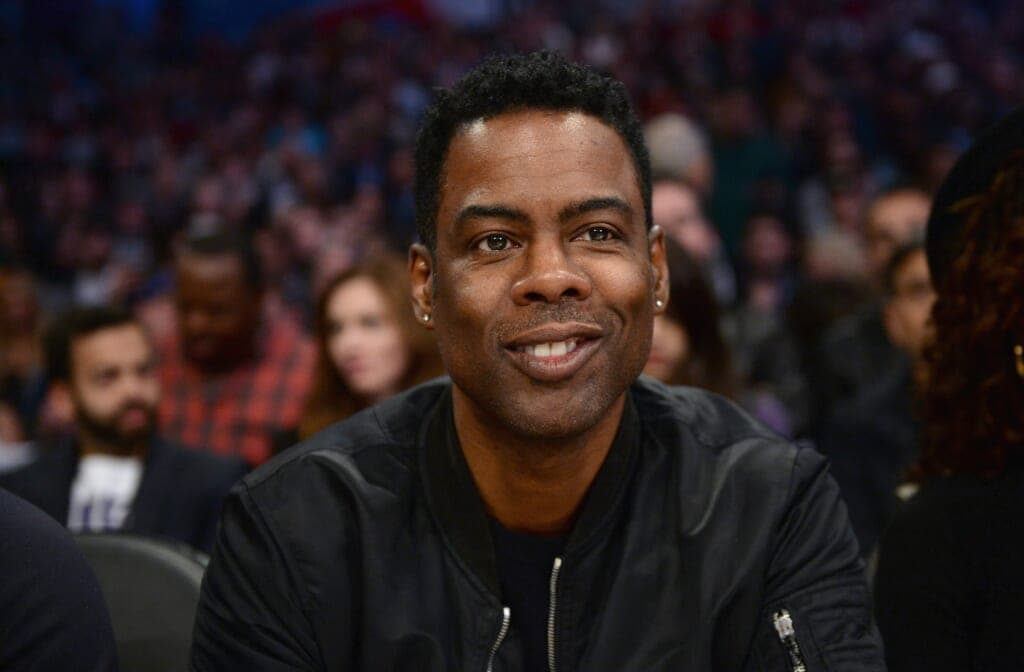 Comedian Chris Rock wearing a black jacket