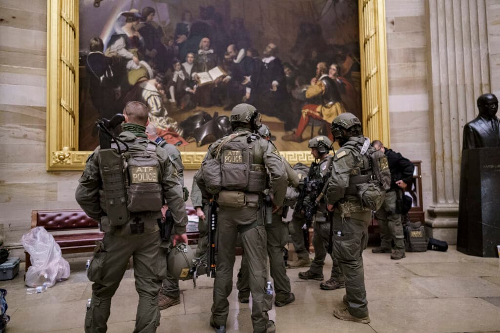 A tactical team with ATF gathers in the Rotunda to provide security