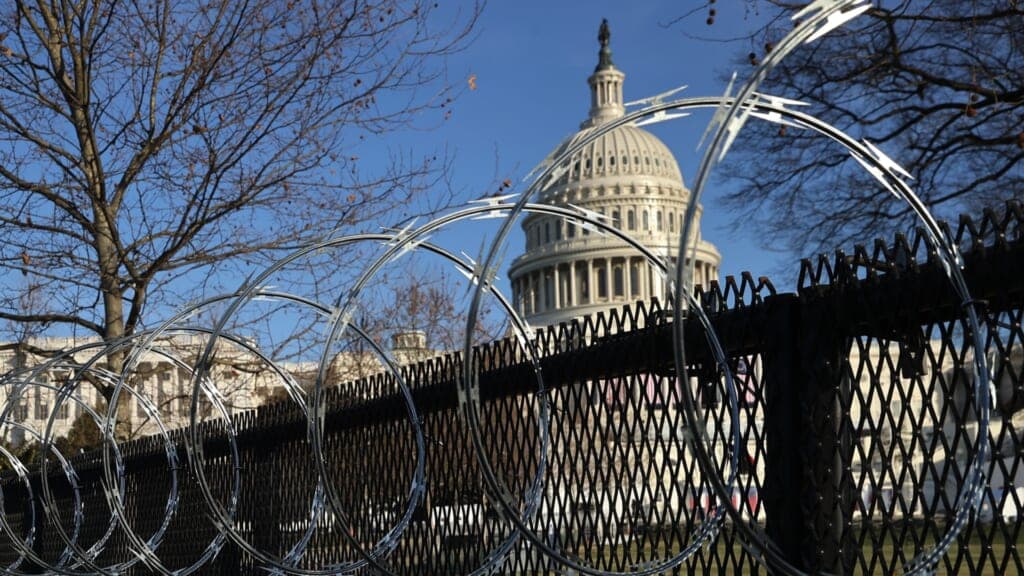 Concertina razor wire is shown along the top of the eight-foot “non-scalable” fence that surrounds the U.S. Capitol