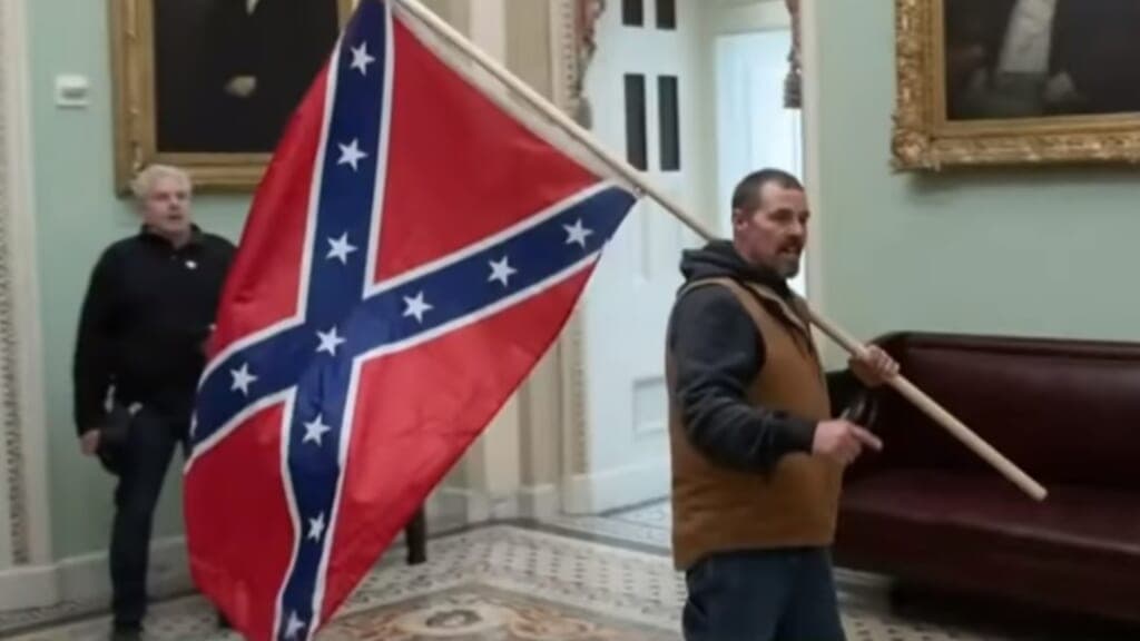Capitol rioter Kevin Seefried carrying a Confederate flag