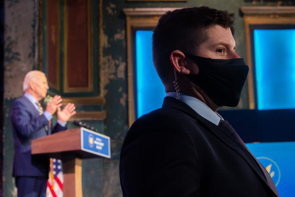 A Secret Service agent with President Joe Biden in the background