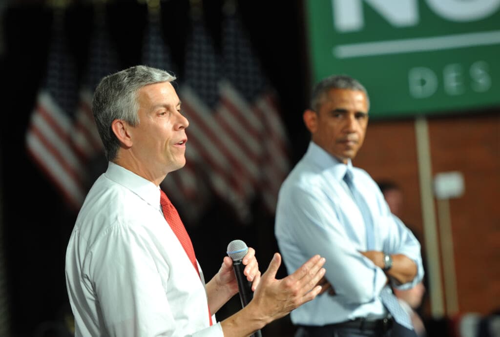 Secretary of Education Arne Duncan speaks alongside former President Barack Obama