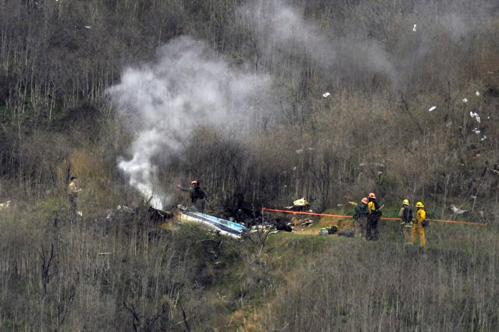 Firefighters work the scene of the Kobe Bryant helicopter crash