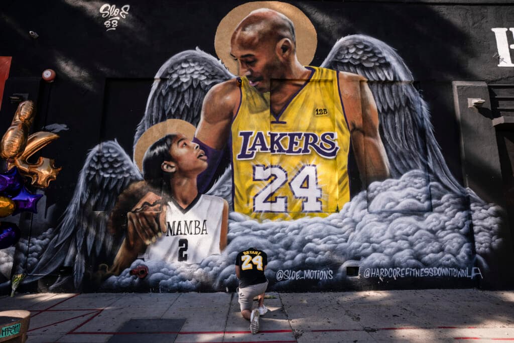 Adam Dergazarian pays his respects for Kobe Bryant and his daughter, Gianna, in front of a mural