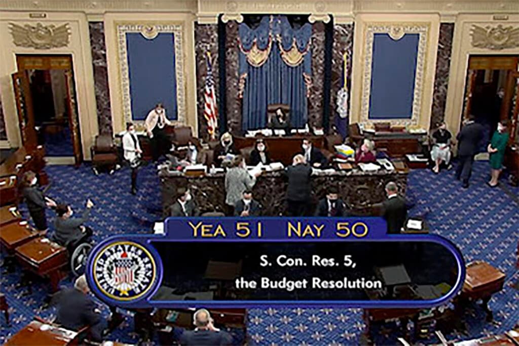 Vice President Kamala Harris sits in the chair on the Senate floor to cast the tie-breaking vote
