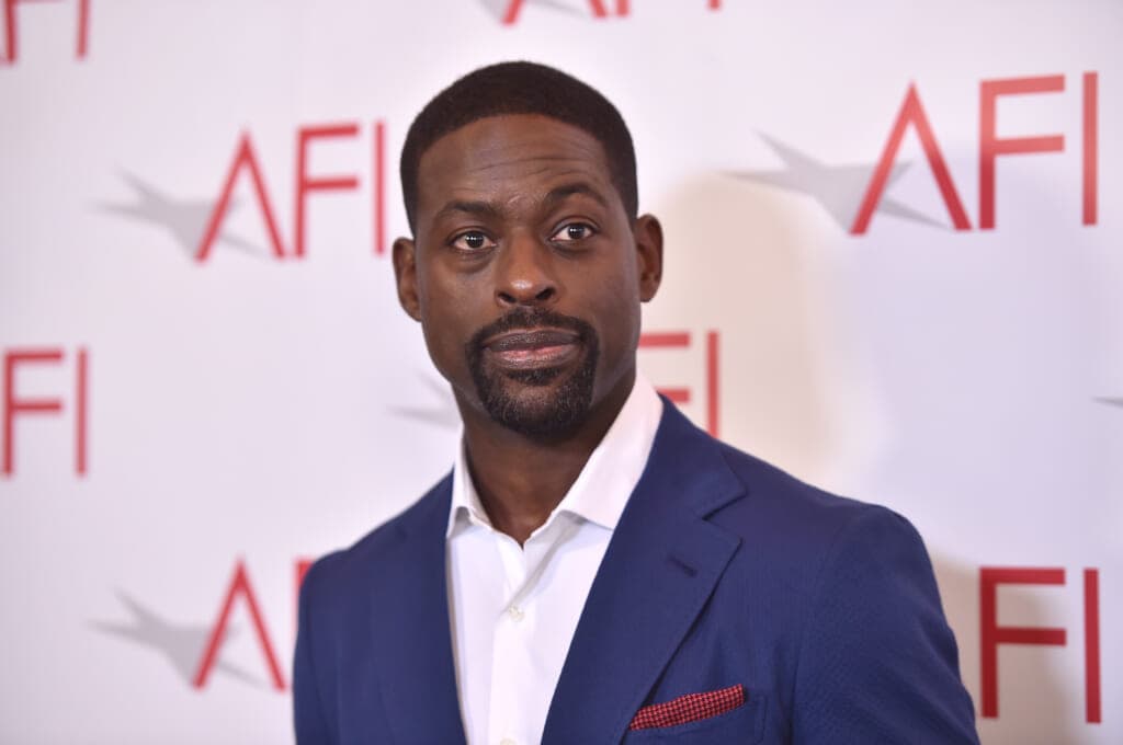 Actor Sterling K. Brown wearing a blue jacket and white shirt