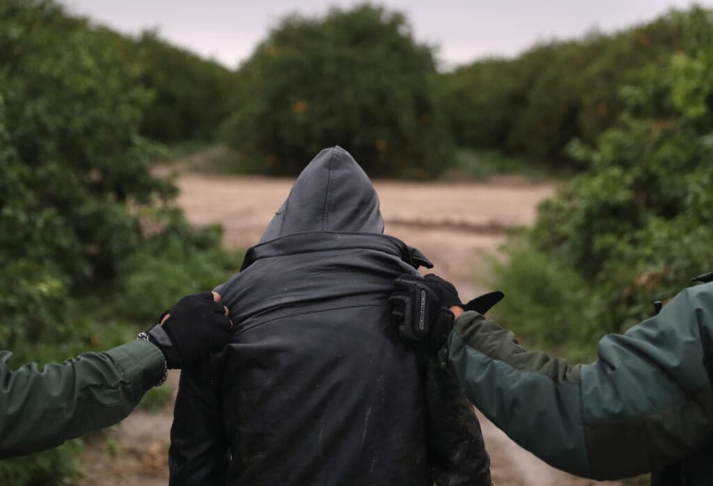U.S. Border Patrol agents detain an undocumented immigrant