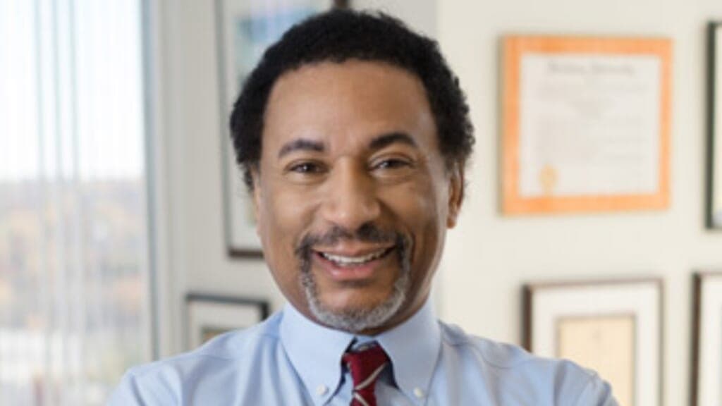 Attorney and author Lawrence Otis Graham wearing a light blue shirt and maroon tie