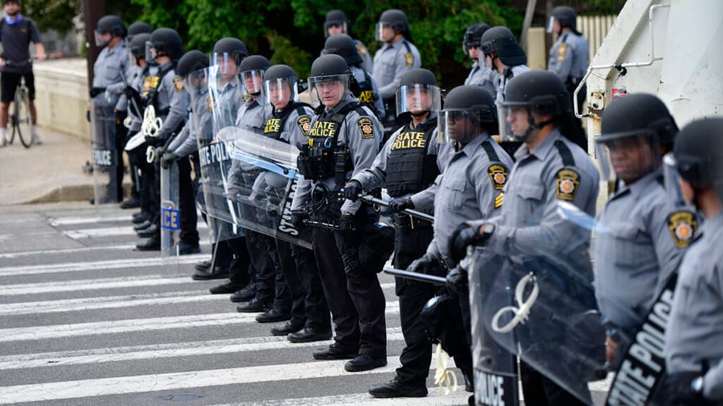 Police form a line to disallow access for a protest march