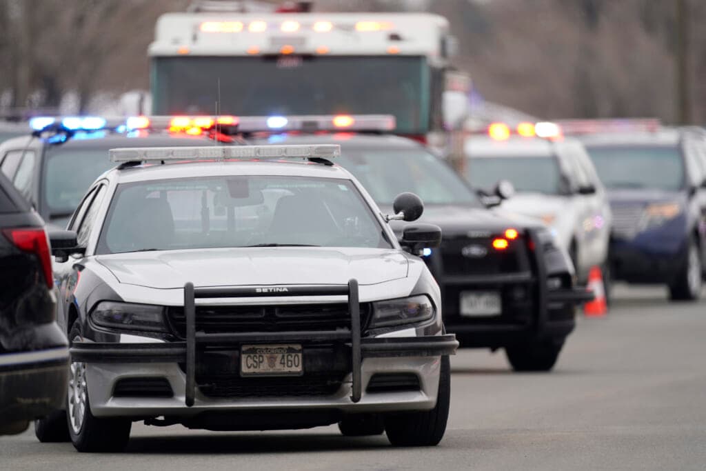 Police cars are parked outside a King Soopers grocery store where a shooting took place