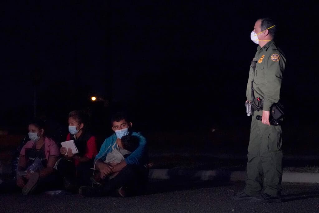 Migrant man holds child