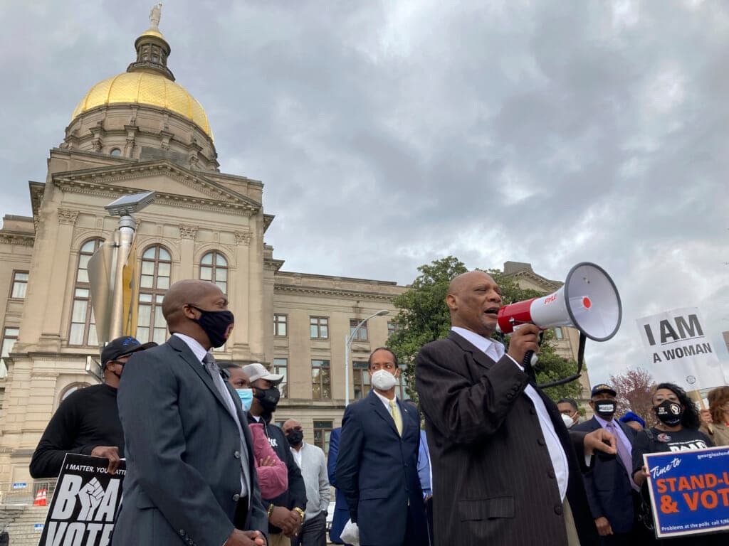 Bishop Reginald Jackson speaks through a bullhorn