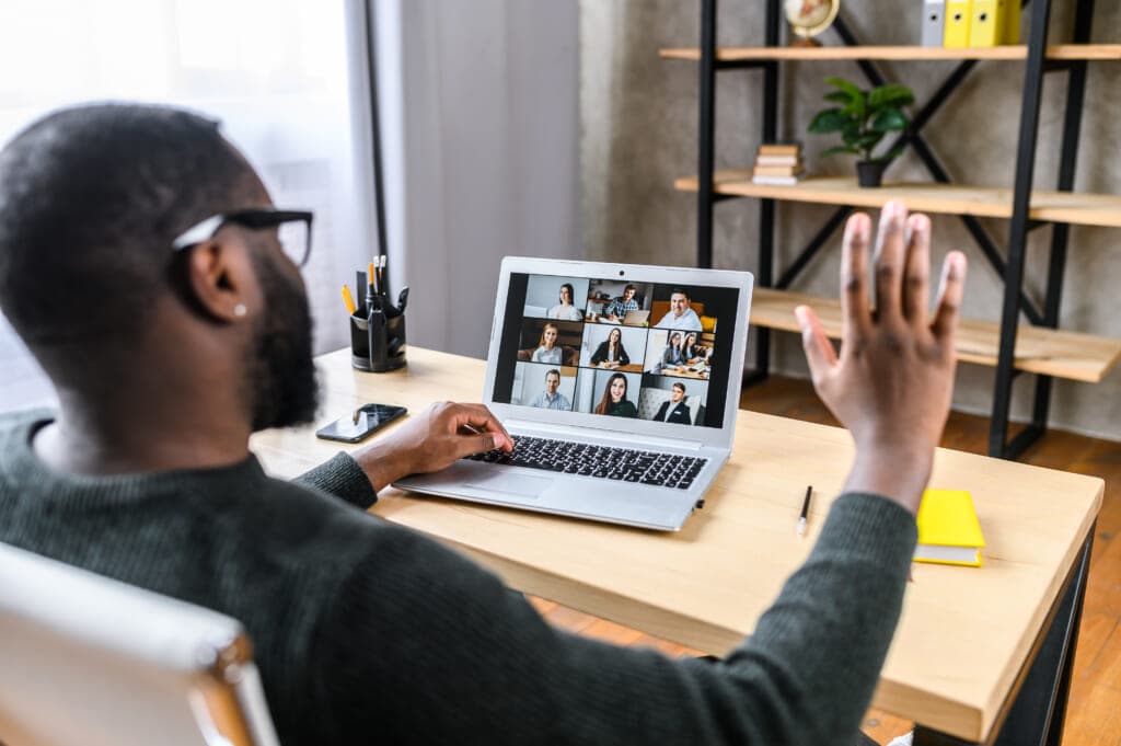 A man takes a video call on a laptop