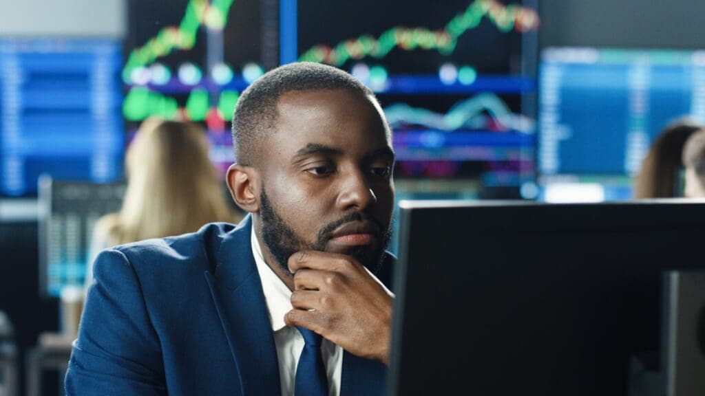 A man concentrates as he looks at a computer screen
