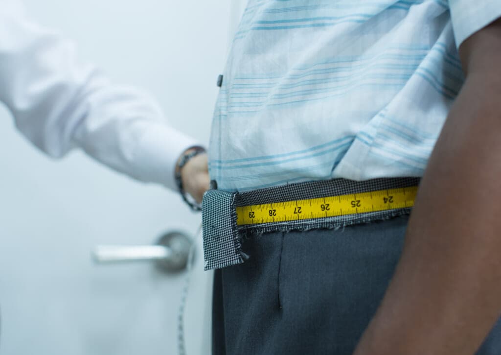 Black man has waist measured