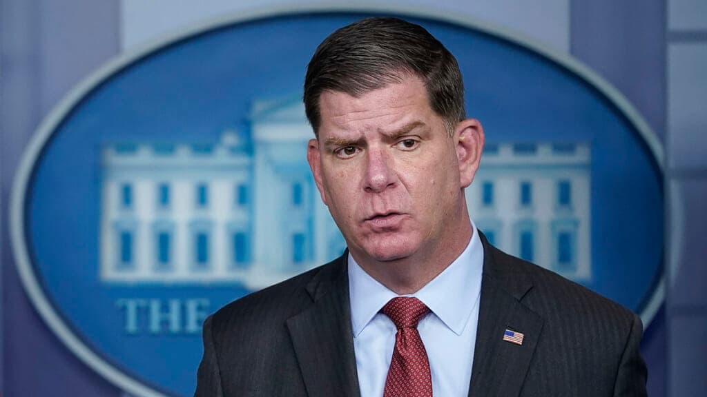 U.S. Labor Secretary Marty Walsh wearing a black jacket and red tie