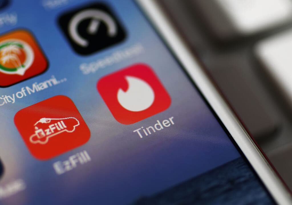 The icon for the dating app Tinder on the screen of an iPhone