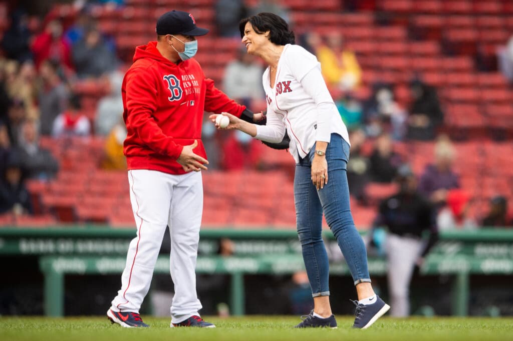 CDC Director Rochelle Walensky receives a baseball from Christian Vazquez of the Boston Red Sox