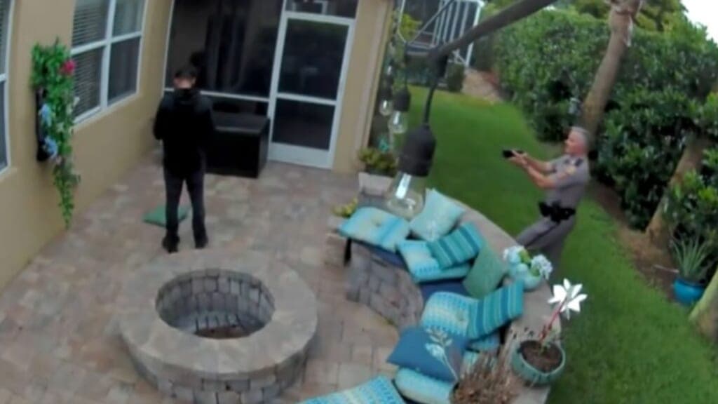 Trooper George Smyrnios (right) is seen on video approaching Jack Roseman with his taser drawn