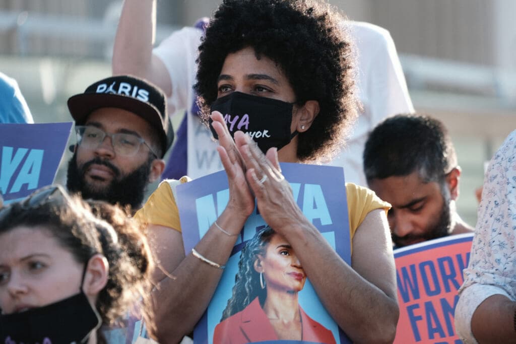 People in a crowd hold posters of New York City mayoral candidate Maya Wiley