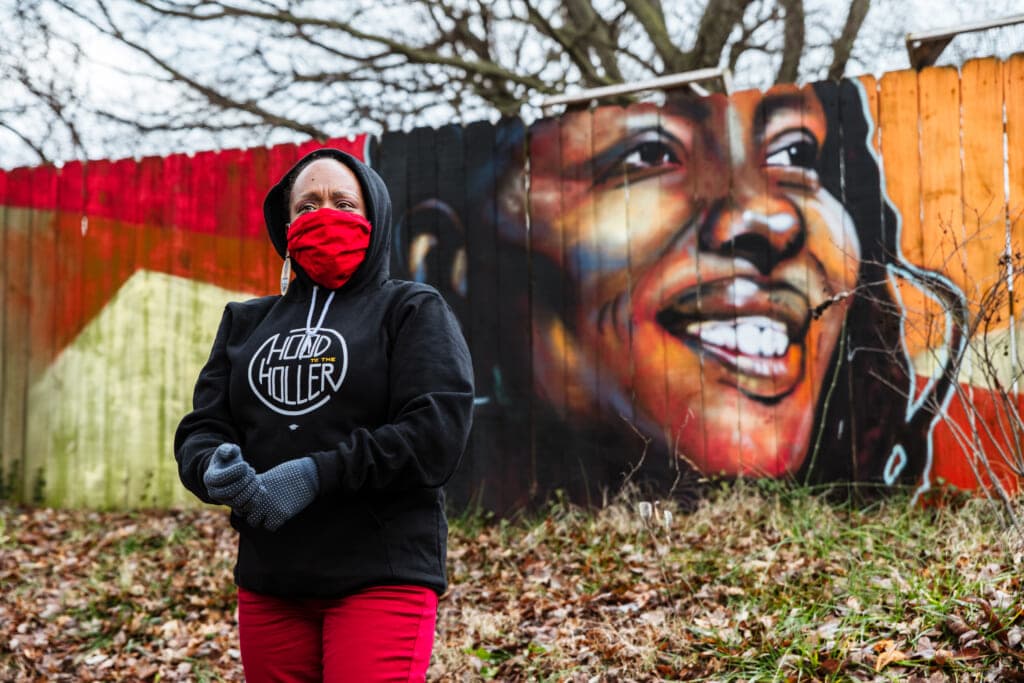Democratic Representative Attica Scott of Kentucky in front of a mural of herself