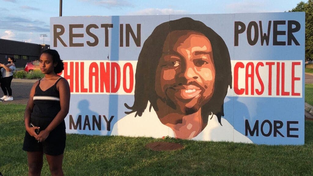 Semhar Solomon in front of her Philando Castile mural