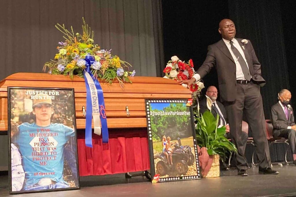 Attorney Ben Crump stands next to Hunter Brittain’s casket