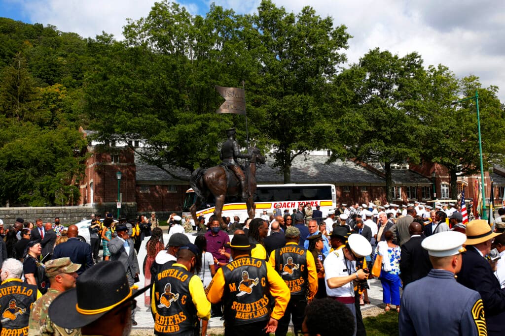 People attend a dedication of a statue honoring Buffalo Soldiers at Buffalo Soldier Field in West Point Military Academy