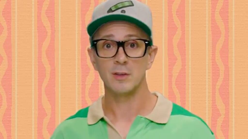Steve Burns, original host of "Blue's Clues," wearing a white baseball cap and green shirt