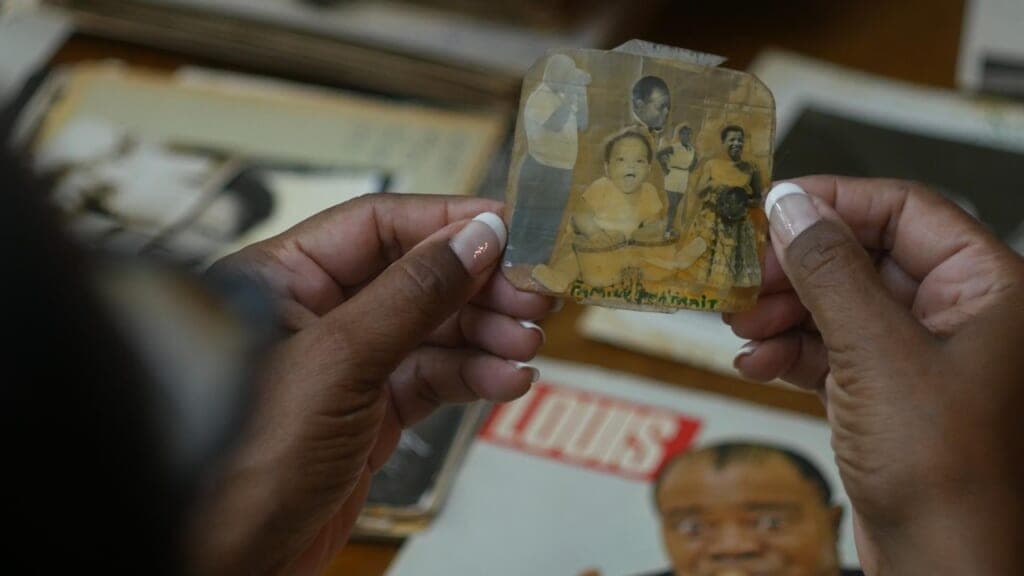 Sharon Preston-Folta overlooks “Family Portrait” collage created by her father, Louis Armstrong