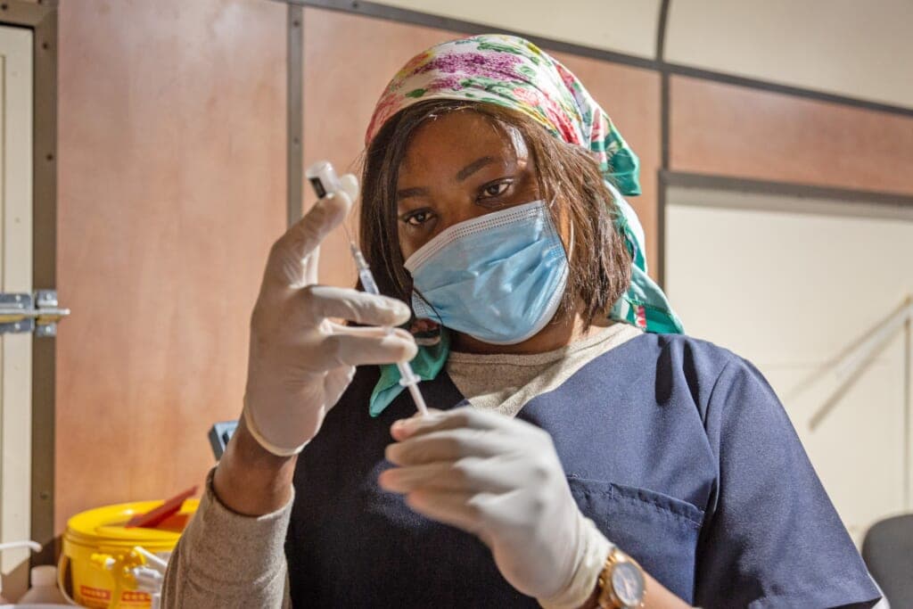 A health worker prepares to administer the COVID-19 vaccine
