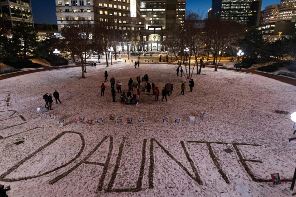 Protesters write Daunte Wright’s name in the snow