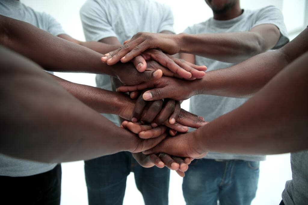 Several people with their hands stacked