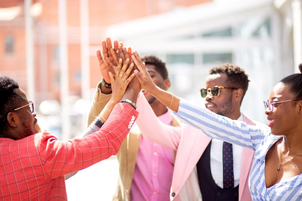 A group of people high-five together