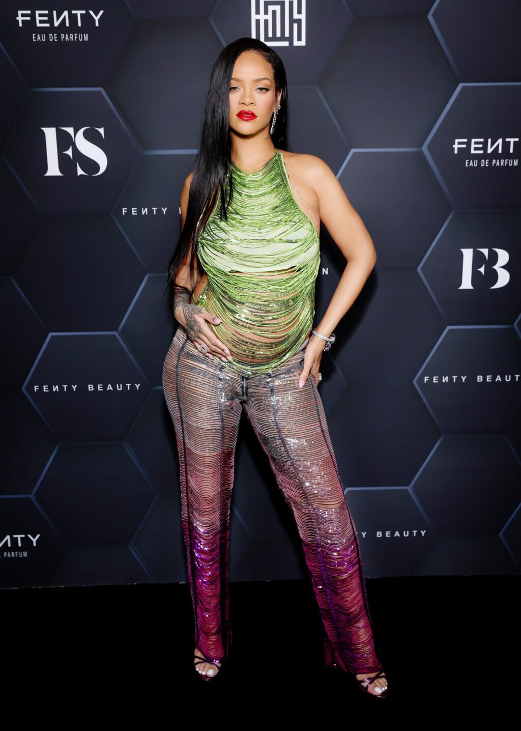 Singer and actor Rihanna in a glittering green sleeveless top and gradiated pink pants