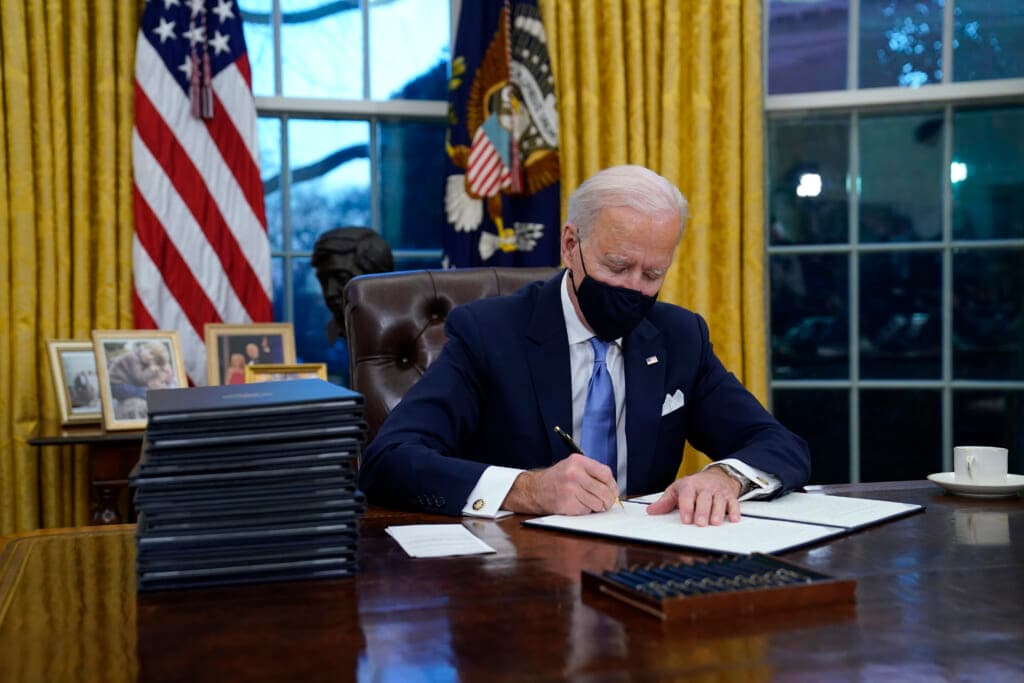 President Joe Biden signs his first executive order