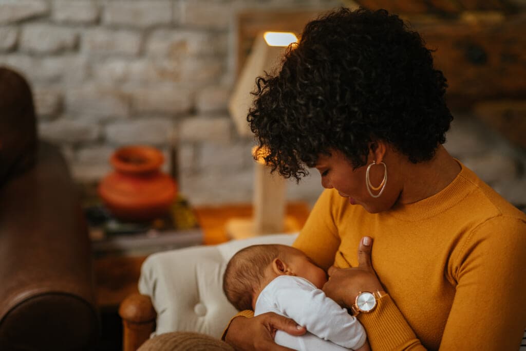 A woman breastfeeds her baby