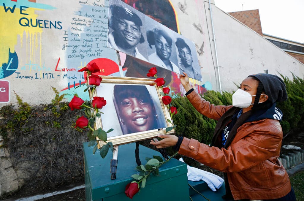 Janice Duncan, creative producer for the documentary film “A Love Song for Latasha” with a portrait of Latasha Harlins