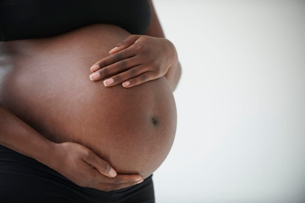 A woman holding her pregnant belly