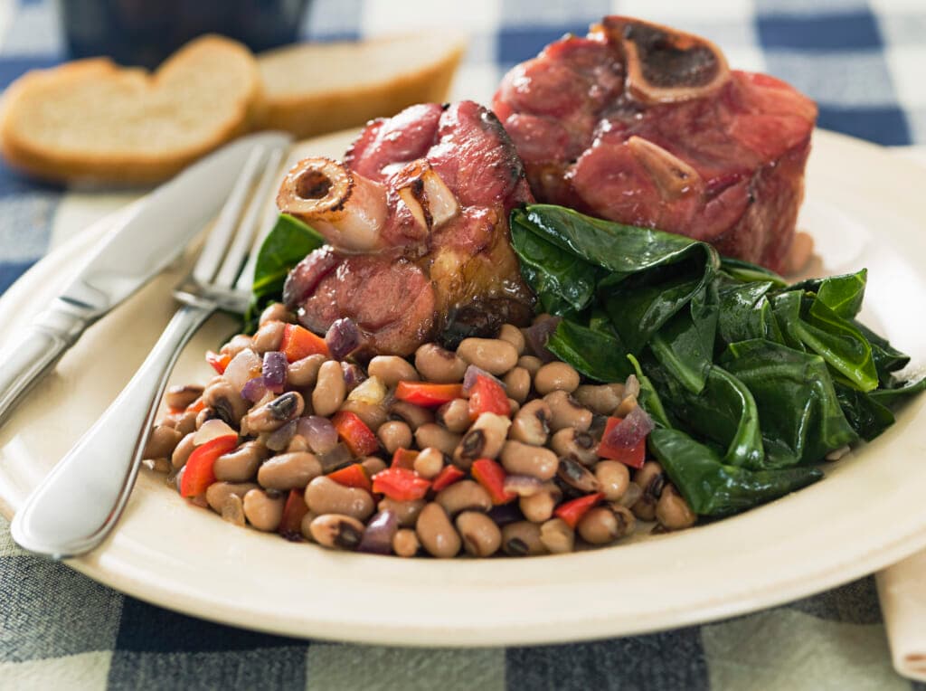 A plate of ham hocks, black-eyed peas and greens