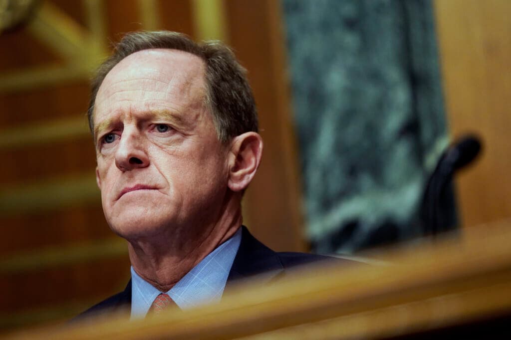 Republican Senator Pat Toomey of Pennsylvania is shown wearing a blue shirt, navy jacket and red tie