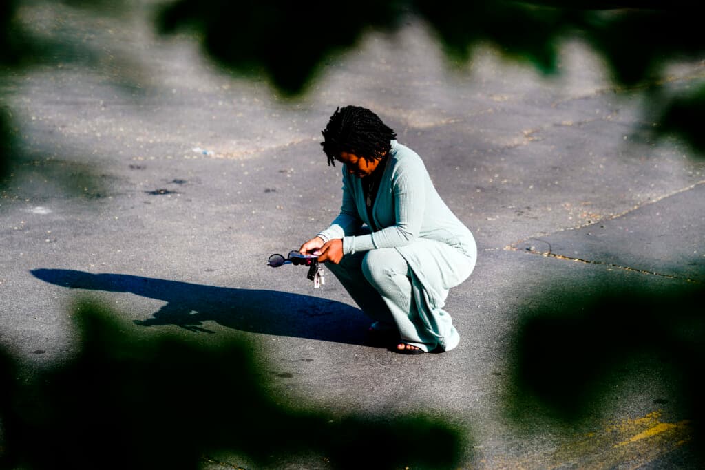 A person pauses outside the scene of a shooting