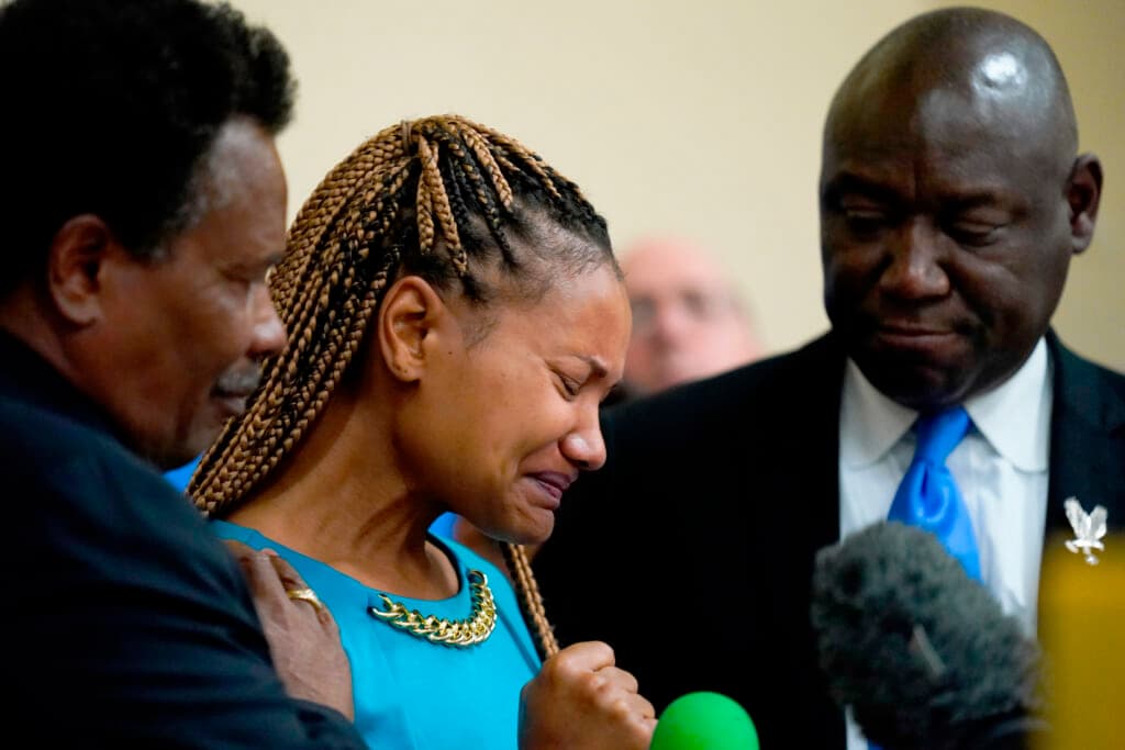 Kamilah Whitfield, center, a granddaughter of Ruth Whitfield