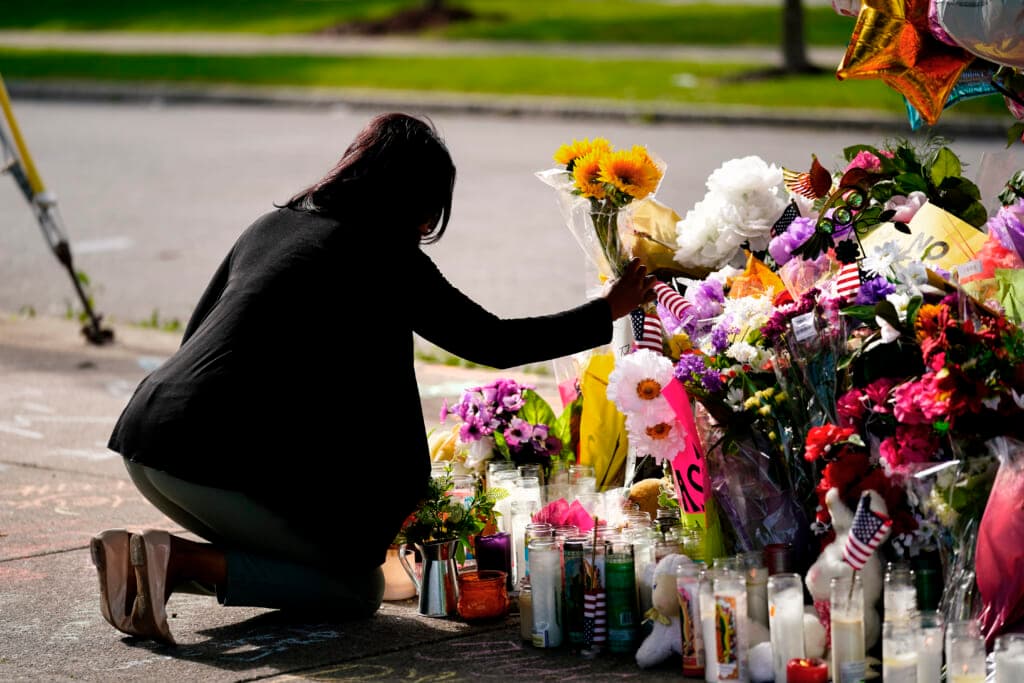 Shannon Waedell-Collins pays her respects at the Tops supermarket
