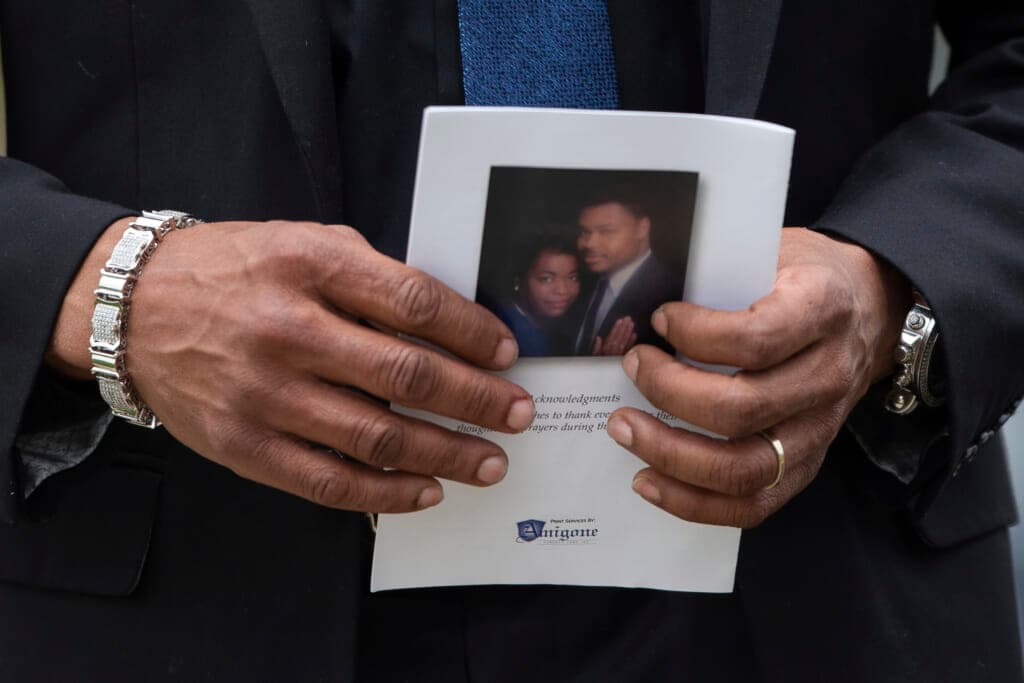 A person holds a program for the funeral service for Aaron Salter Jr.